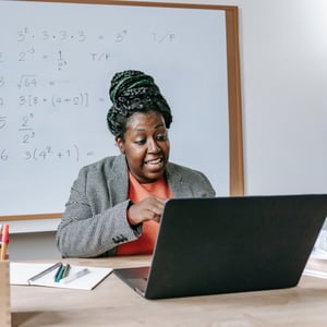 Woman in front of a computer, taking an online class