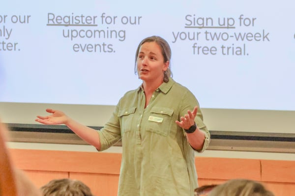 Carly Epstein speaking in front of an audience.