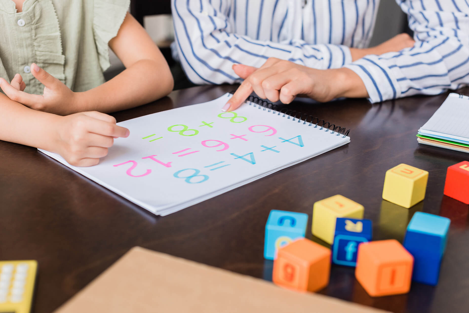 cropped-shot-of-mother-and-daughter-learning-math-2021-08-30-19-51-44-utc