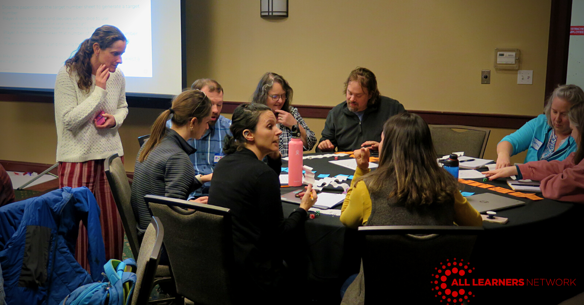 Teachers gathered around a table with manipulatives