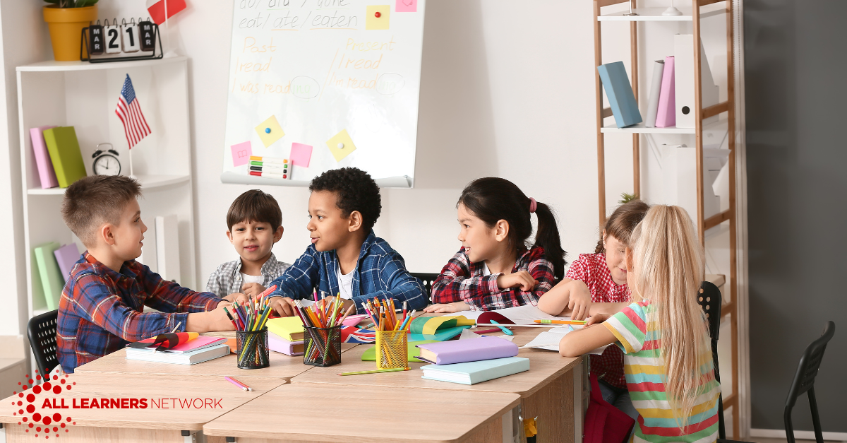 Kids gathered around a desk talking