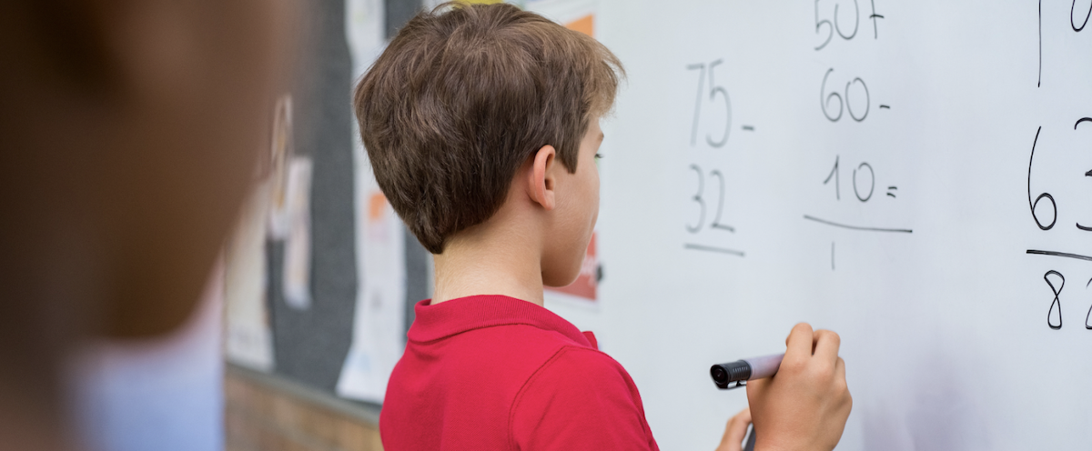 student using math strategies at white board